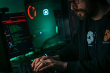 man in black jacket using computer